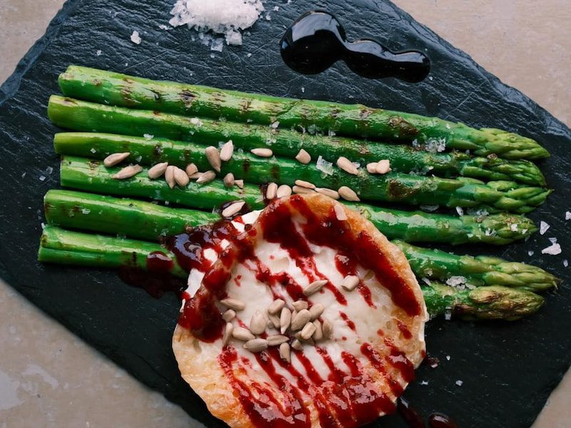 Grilled asparagus with goat’s cheese, red fruit vinaigrette & sunflower seeds – a fresh, elegant Spanish dish at Llerena, Islington.